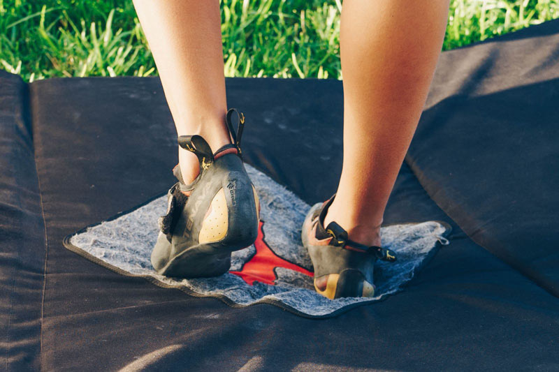 Cleaning Climbing Shoe on Metoulis Crash Pad floor mat