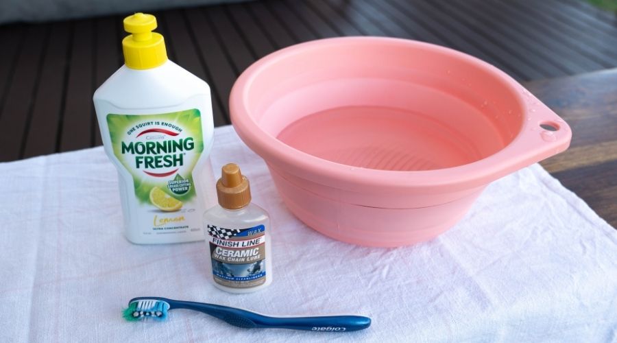 dishwashing liquid, water, bucket, old toothbrush