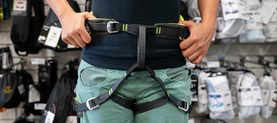 A person pulling down on a harness to ensure it fits securely